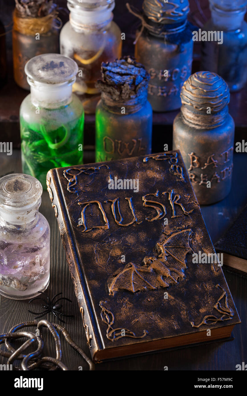 magic book witch apothecary jars potions halloween decoration Stock Photo