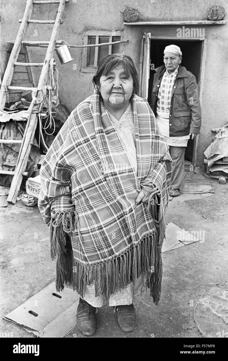 An elderly Taos Indian woman and her husband on the patio of their 800