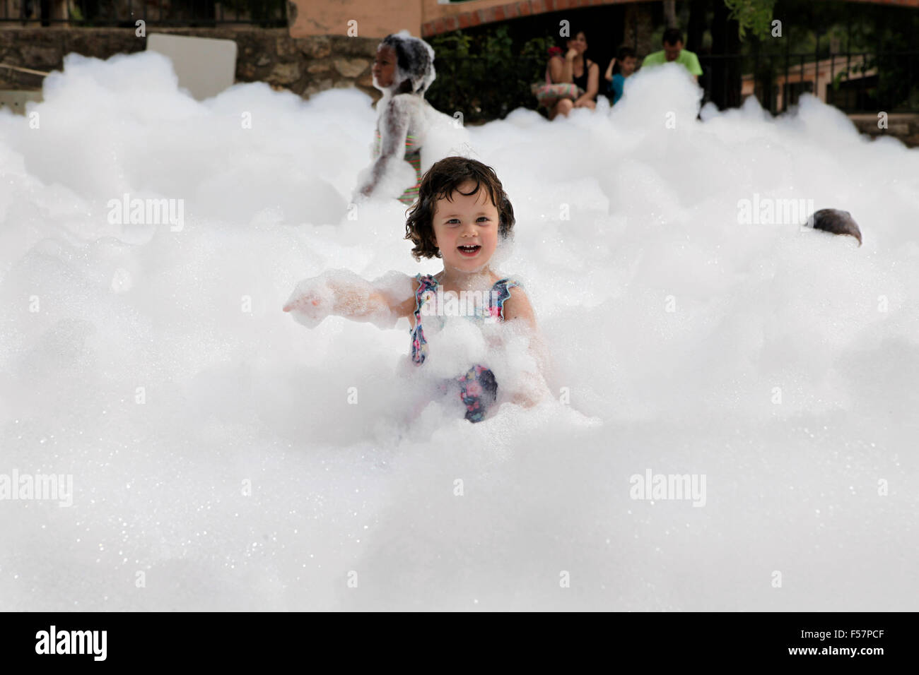 Little child playing in a foam party. Stock Photo