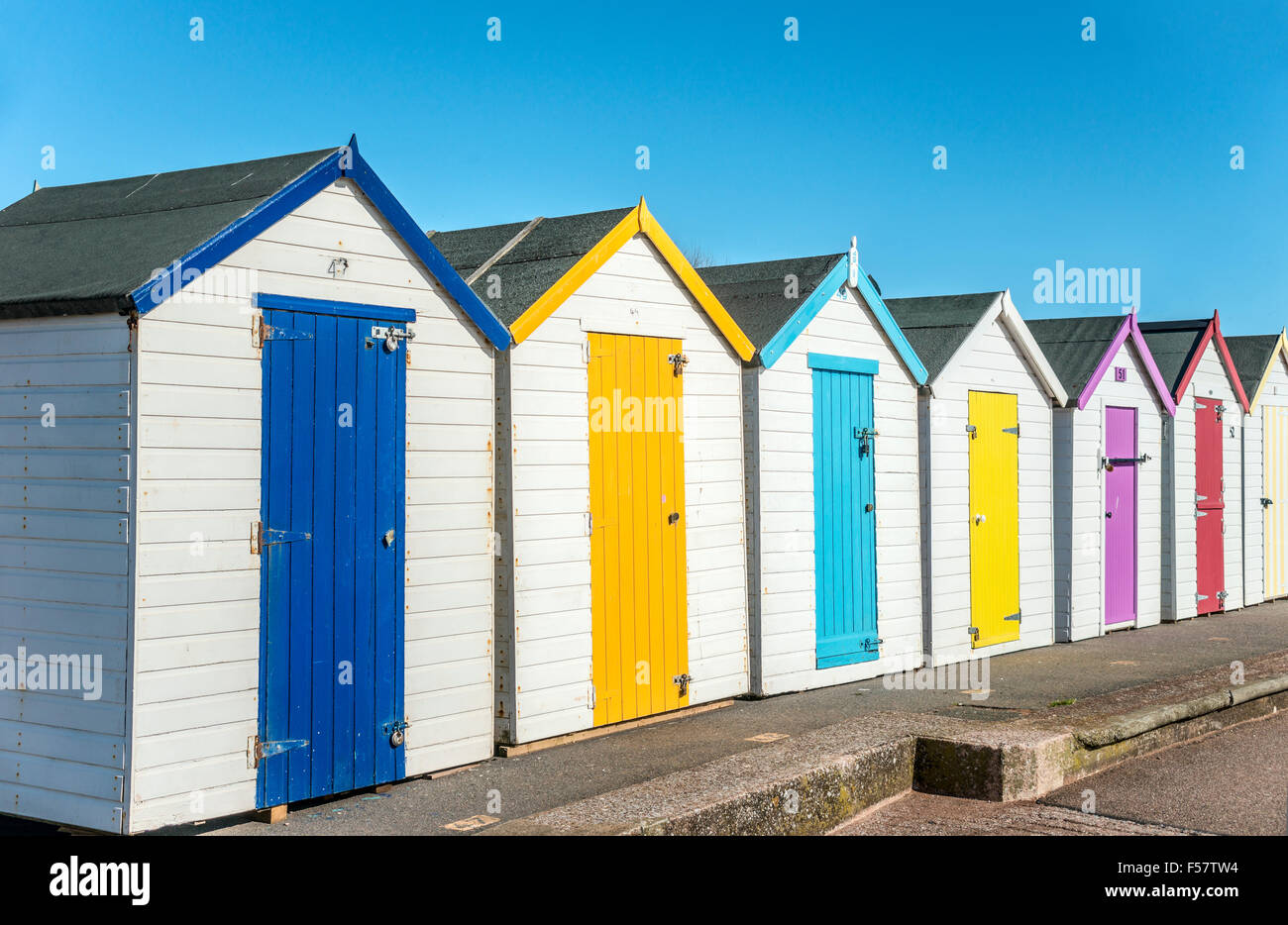 Colourful beach huts at Paignton seafront and beach, Torbay, Devon, England, UK Stock Photo