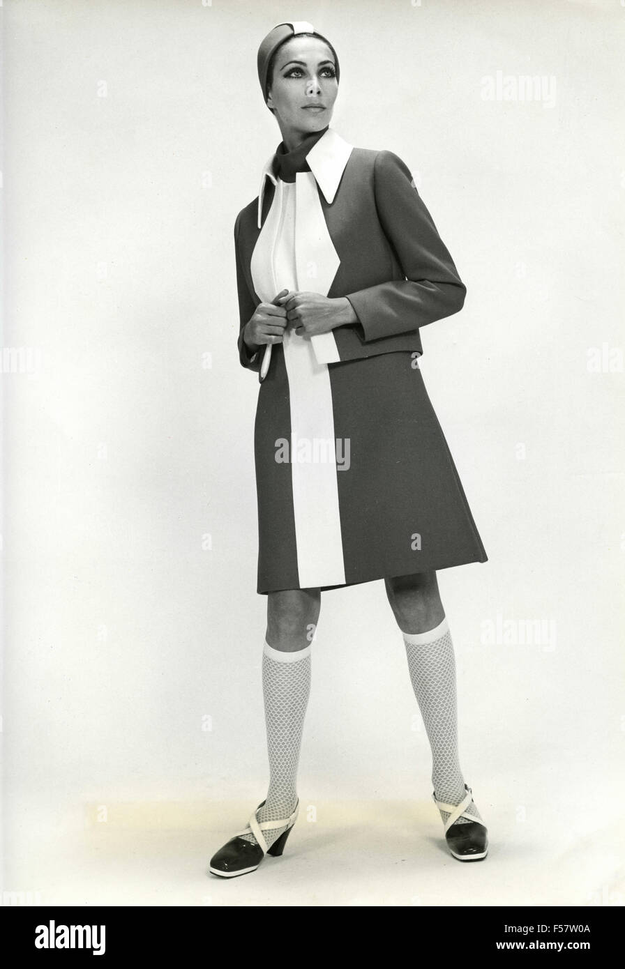 A model wearing a dress in two colors with matching shoes and hat Stock Photo