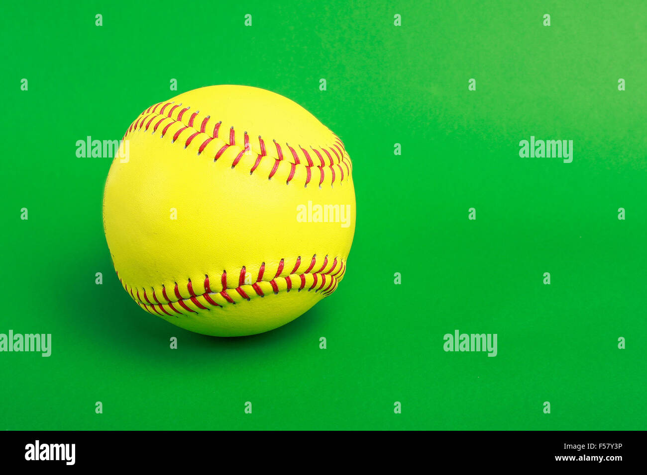 softball ball isolated on green background Stock Photo