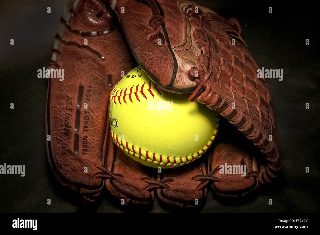 Closeup of a Softball Glove and ball Stock Photo