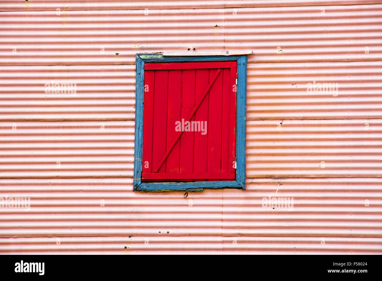 Pink wall with red window in La Boca, Buenos Aires, Argentina Stock Photo