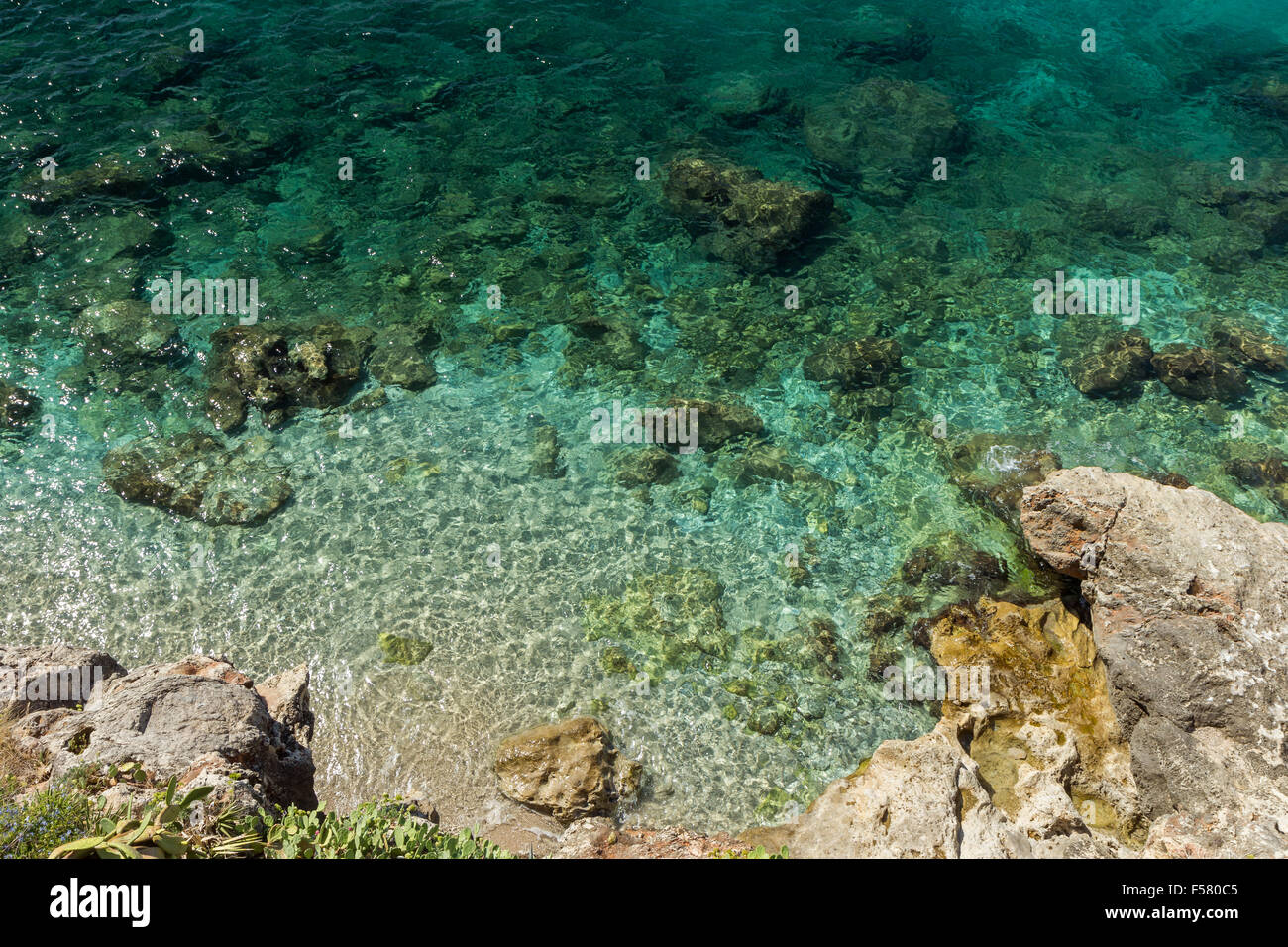 Rocky coastline and shallow water viewed from above in Dubrovnik, Croatia. Stock Photo