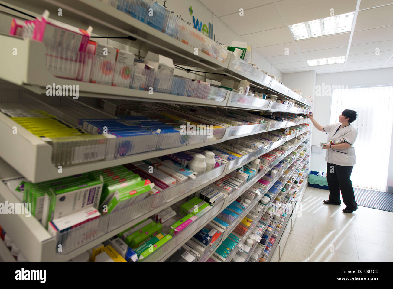 A female pharmacist at work in a chemist / pharmacy in South Wales, UK. Stock Photo