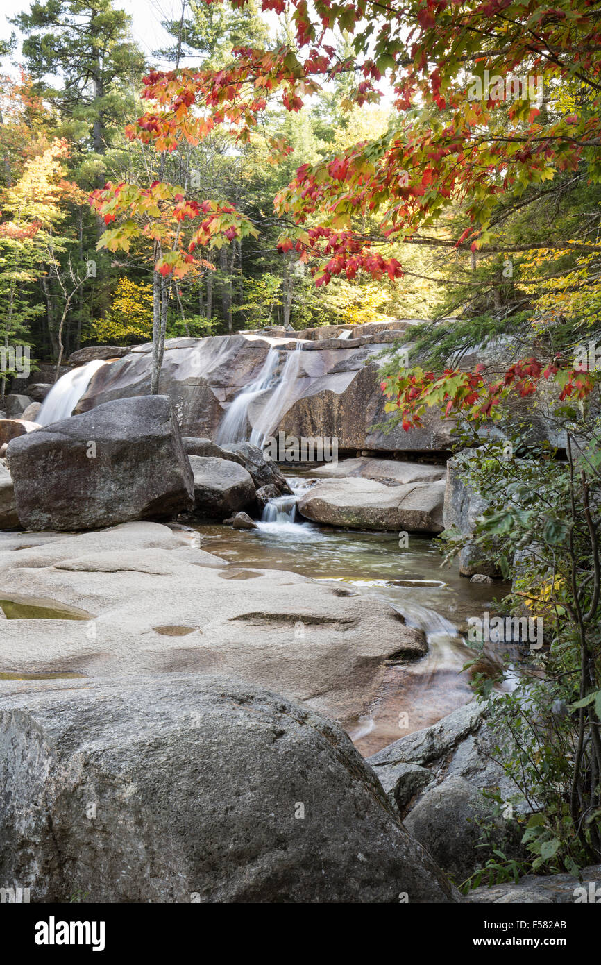 Amber granite with waterfalls of Lucy Brook, and fall foliage at Diana's Baths in Bartlett, New Hampshire. Stock Photo