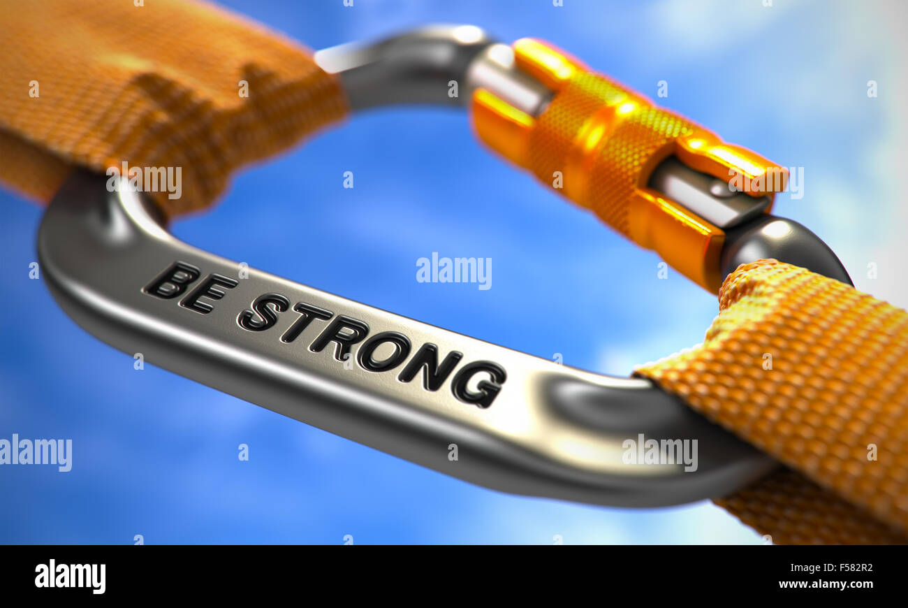Be Strong. Motivational Quote on Chrome Carabine with a Orange Ropes. Selective Focus. Stock Photo