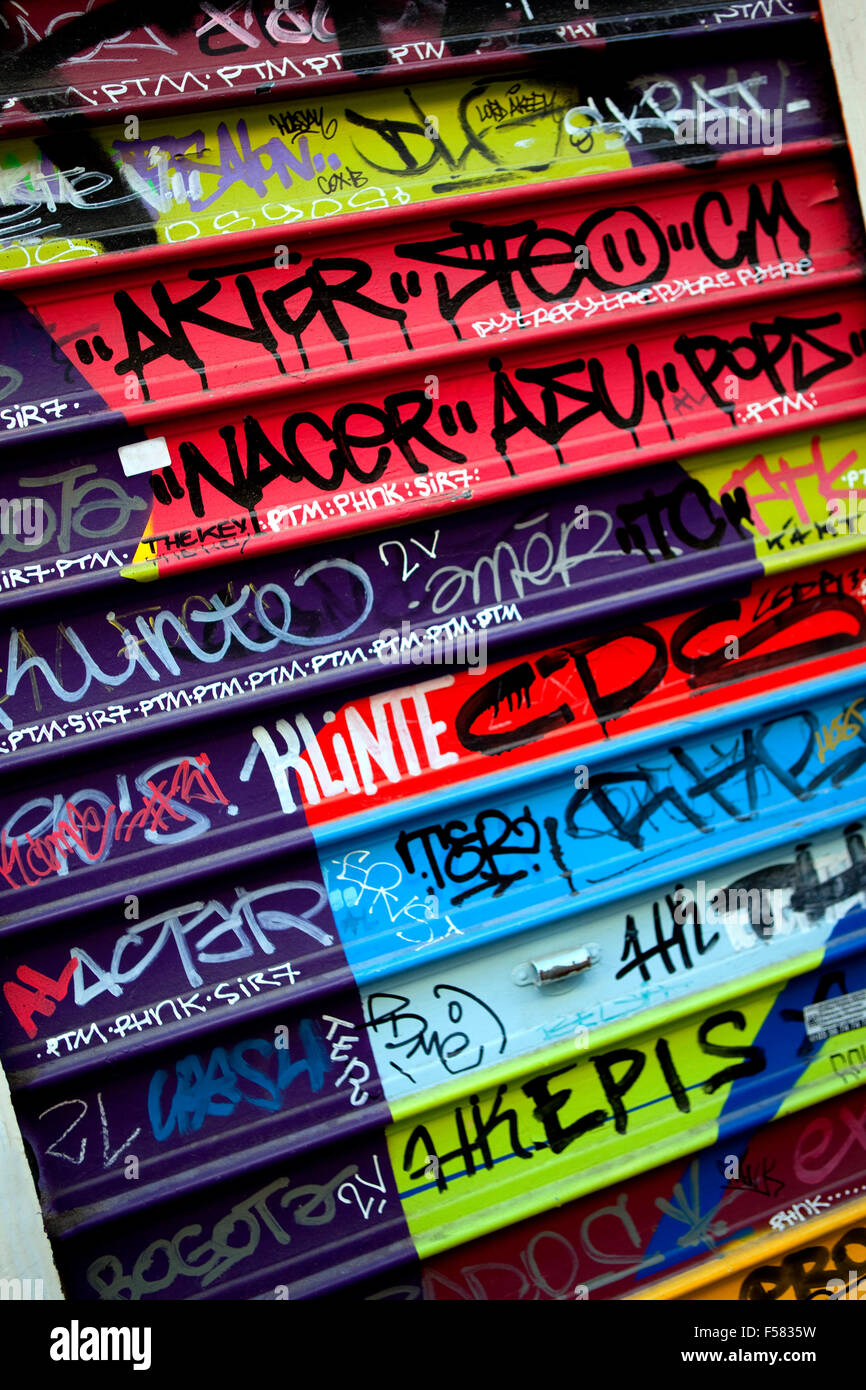 Various graffiti on a colorful iron curtain Stock Photo Alamy