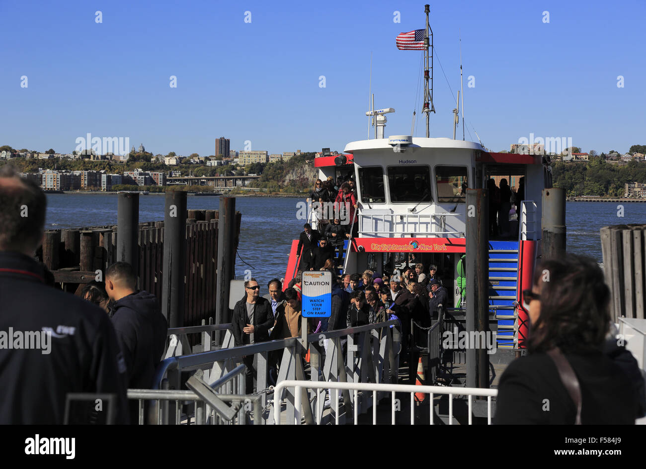 passengers visitors disembark getting off the City Sightseeing Cruise at pier 78. west side of Manhattan, New York City, USA Stock Photo
