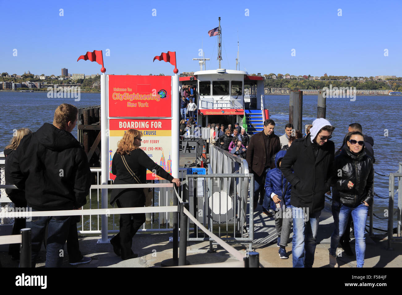passengers visitors disembark getting off the City Sightseeing Cruise at pier 78. west side of Manhattan, New York City, USA Stock Photo