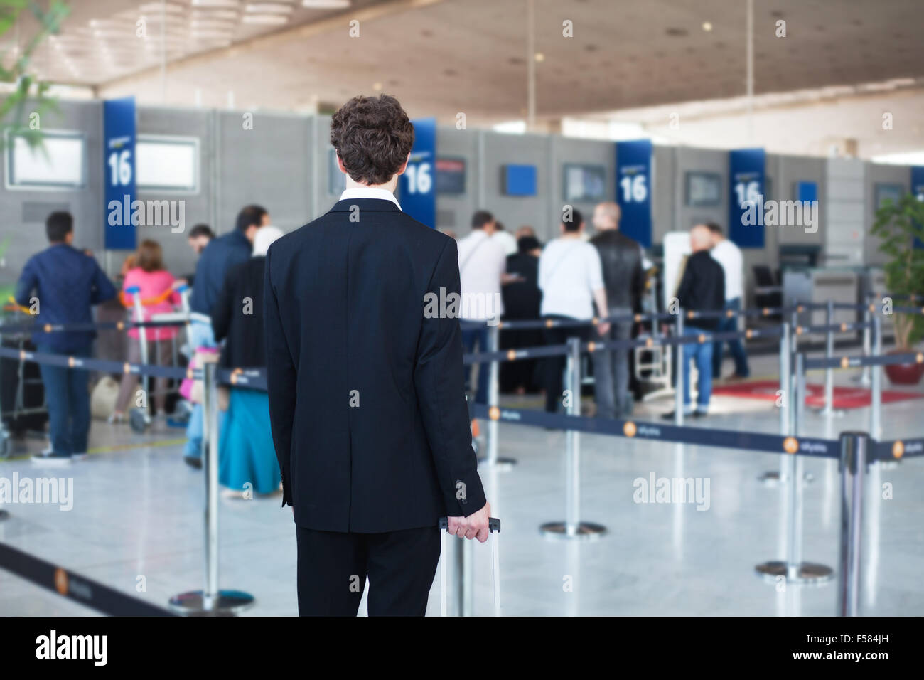 people at the airport, passenger waiting in queue to check in and drop off luggage Stock Photo