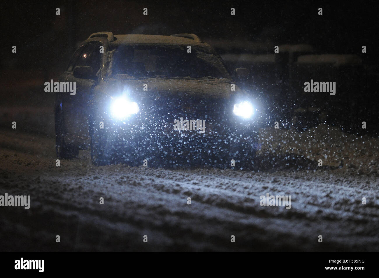 Cars struggle on roads covered in black ice and snow during heavy