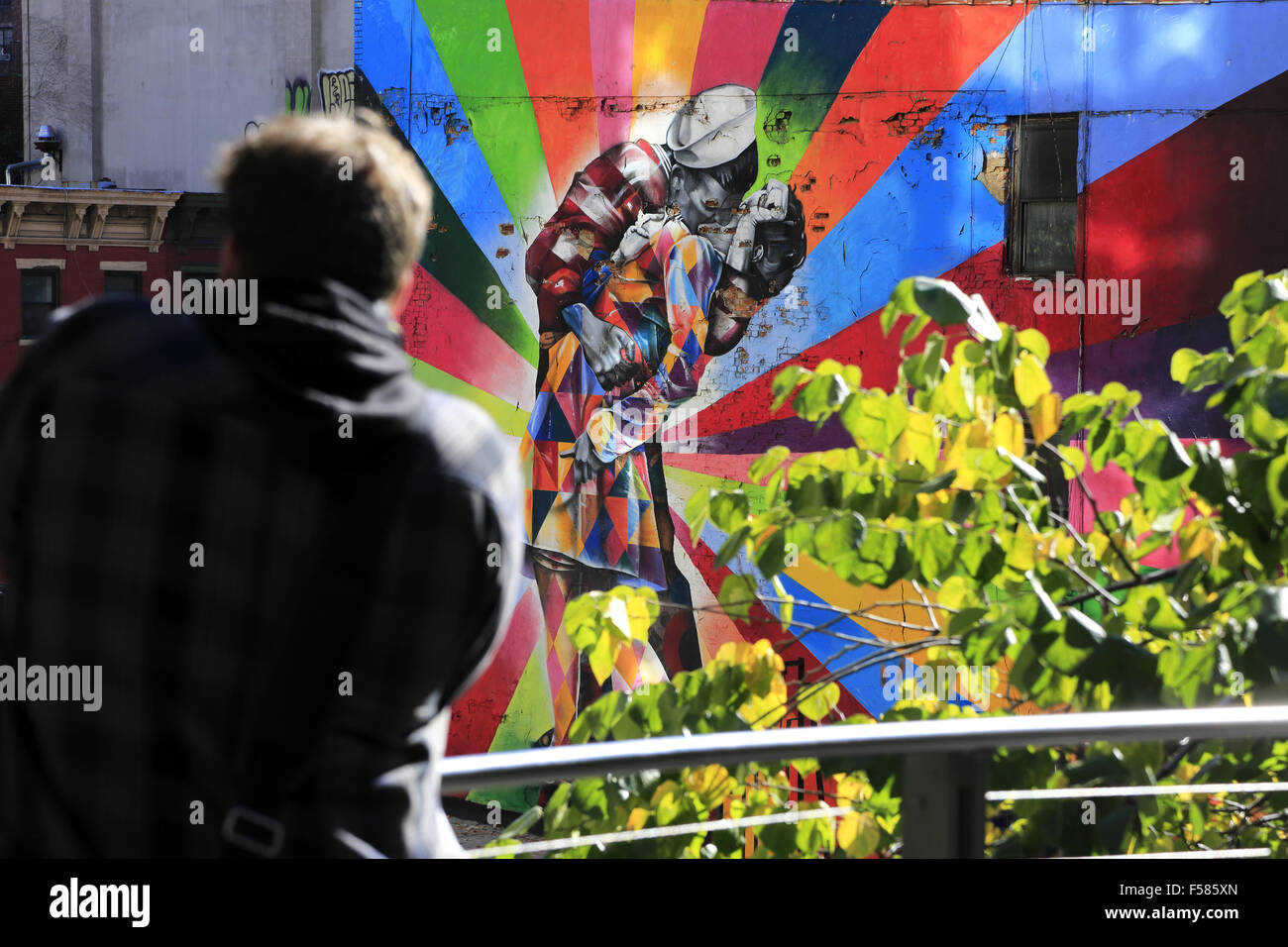 A visitor taking photos of a mural along High Line Park, Manhattan, New York City, USA Stock Photo