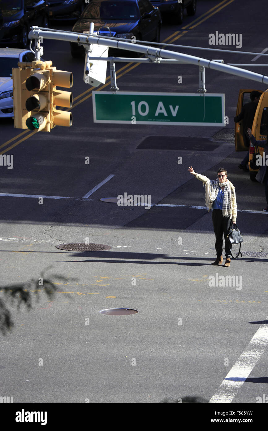 A woman flag a taxi cab in a intersection in Manhattan, New York City