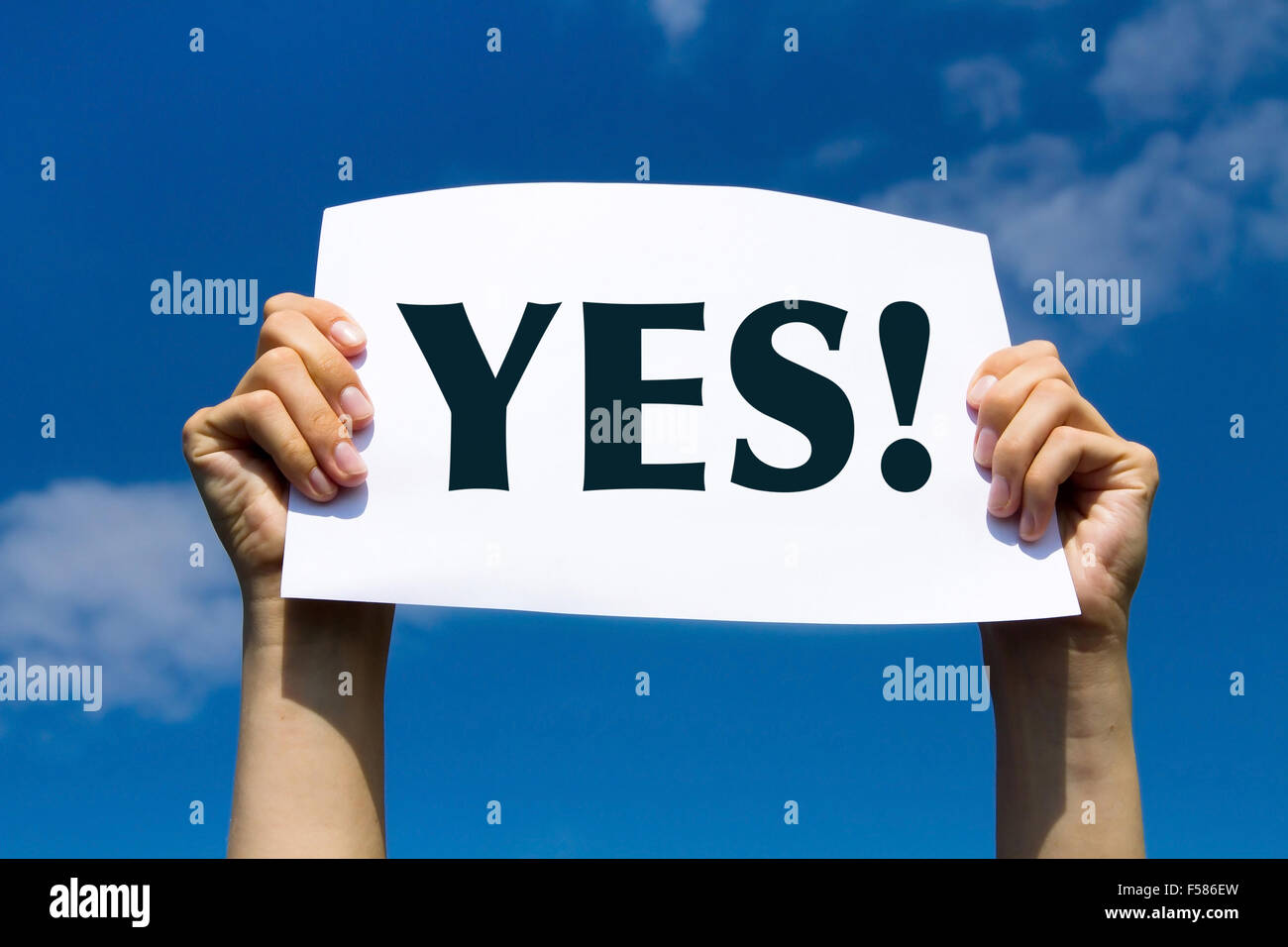 YES concept, positive changes in the life, hands holding white sign on the sky background Stock Photo