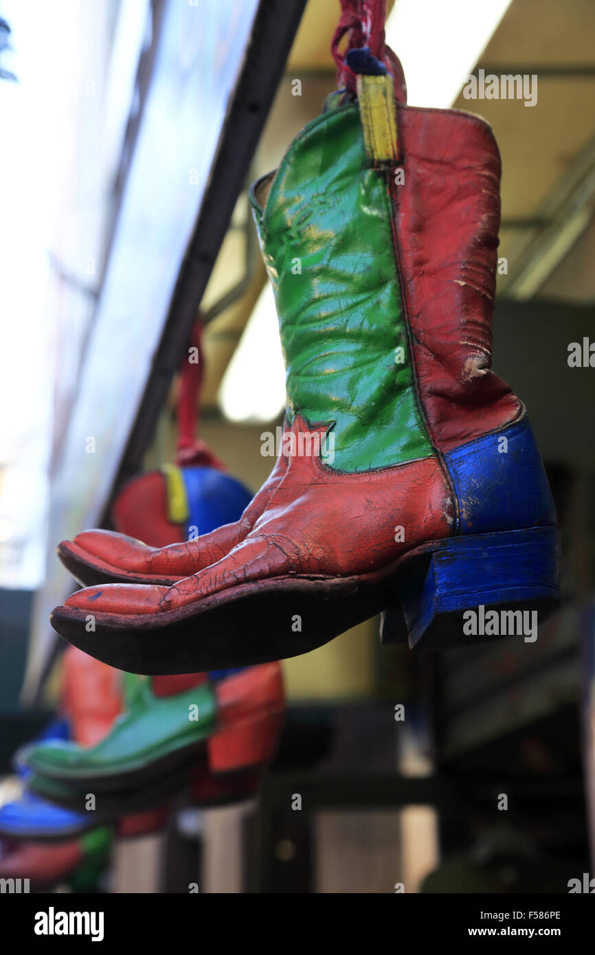 Old cowboy boots hanging outside of a store. Manhattan. New York City. USA  Stock Photo - Alamy