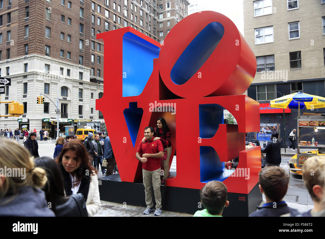 Visitors having their photos taken in front of the Love sculpture at 6th Avenue. midtown