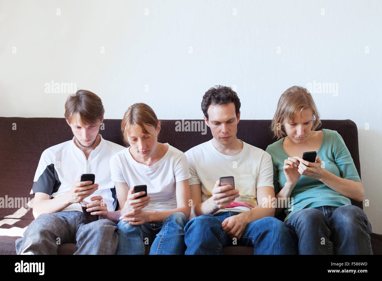 internet addiction, group of young people looking at their smart phones Stock Photo