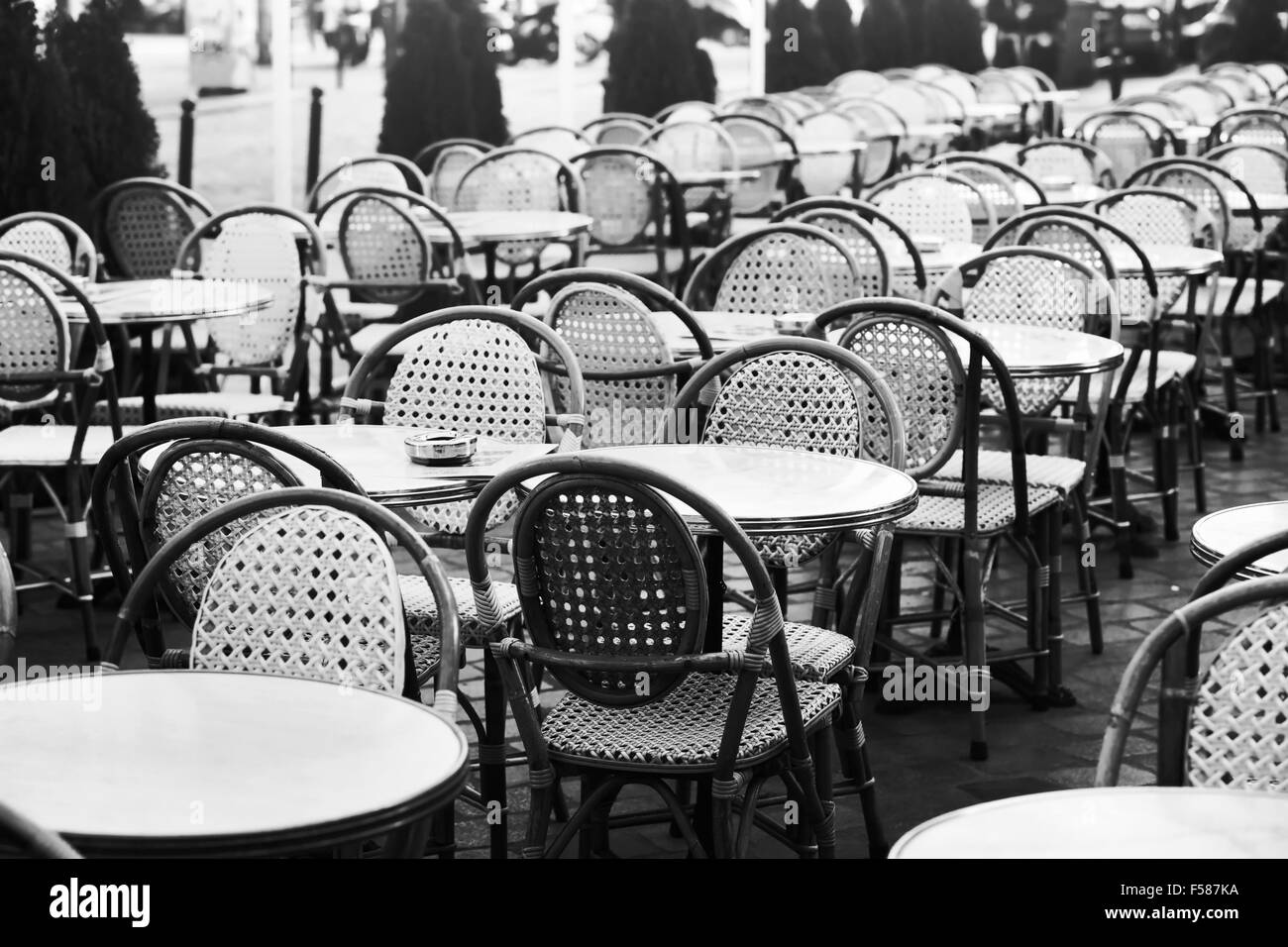 vintage street cafe in Paris, black and white photo of wicker chairs and tables Stock Photo