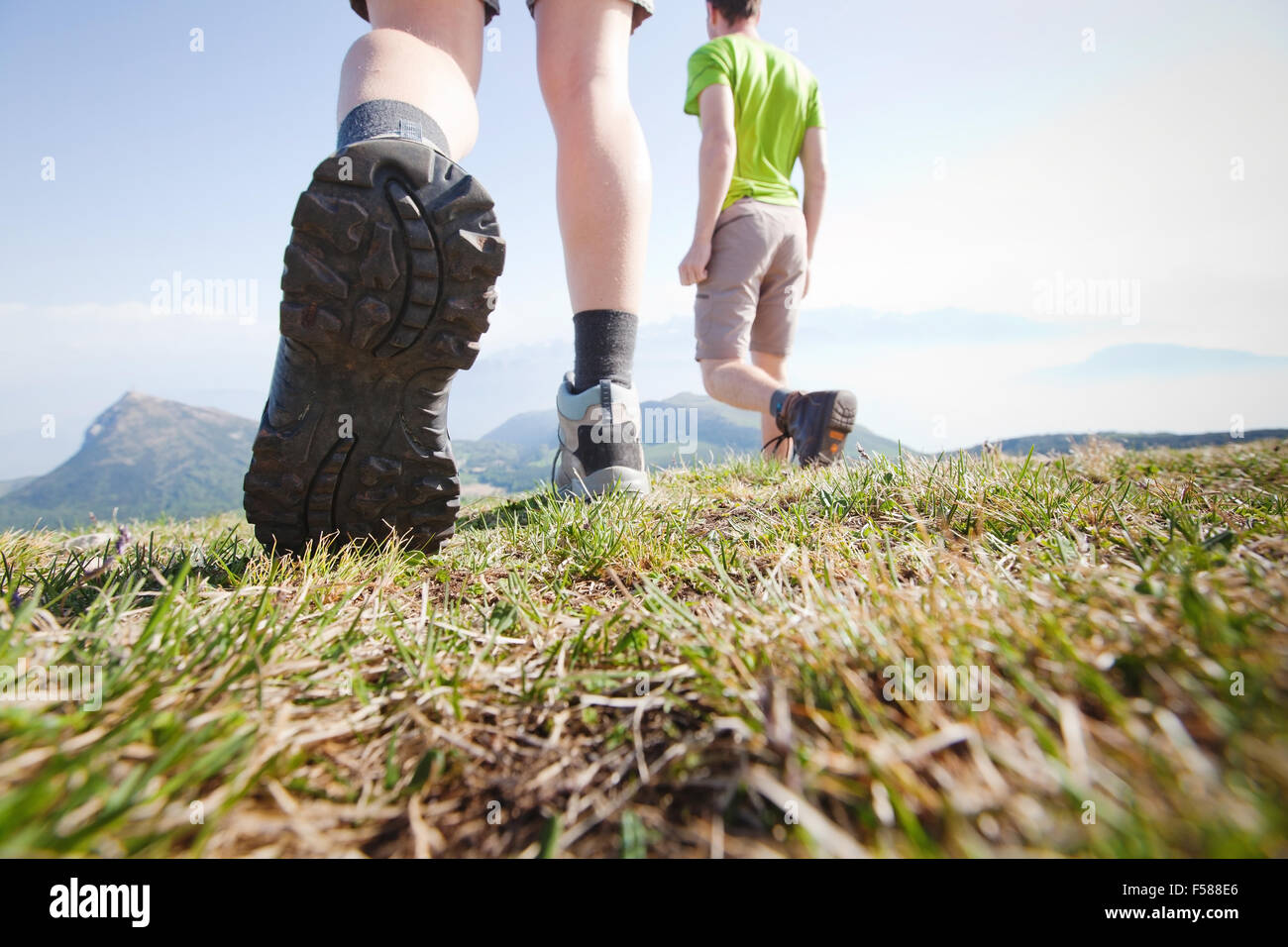 hikers walking in the mountains, close up of the foot, low angle Stock Photo