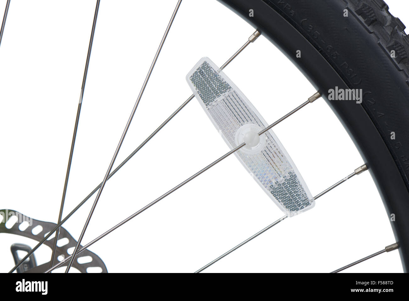 closeup of reflector installed to the spoke of mountain bike, isolated on white. Stock Photo