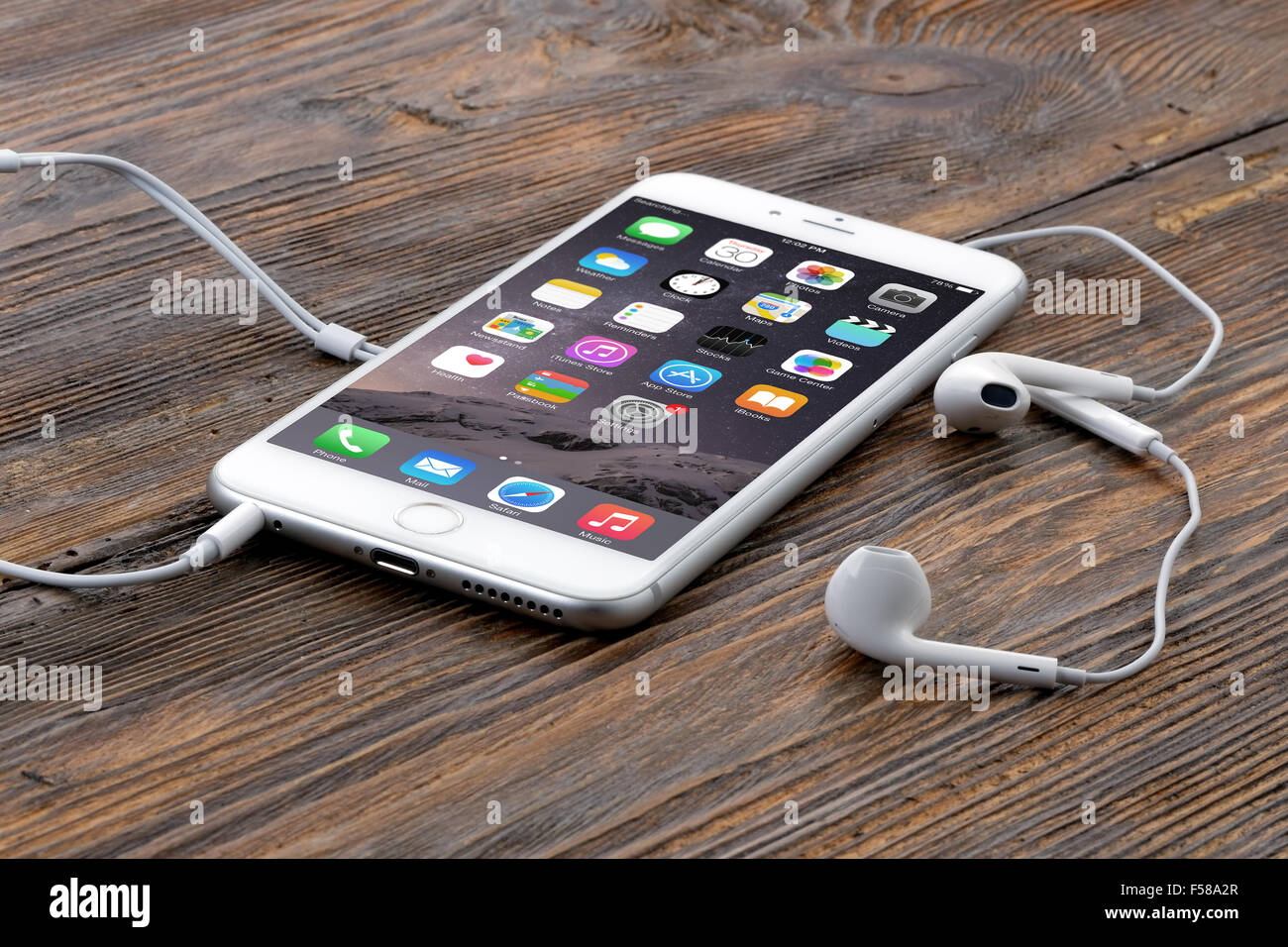 Silver iPhone 6 Plus on wooden table Stock Photo