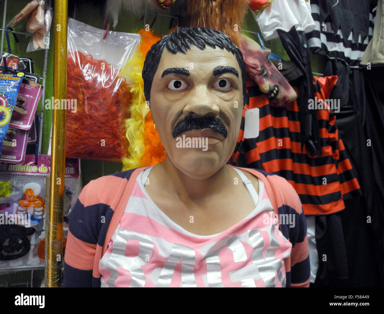 Mexico City, Mexico. 27th Oct, 2015. The mask of Mexican drug kingpin Joaquin 'El Chapo' Guzman in a marketplace in Mexico City, Mexico, 27 October 2015. The fugitive drug lord will turn up this year alongside vampires, zombies, and witches at Halloween parties. The masks of the mustachioed cartel leader are the bestseller in the markets of Mexico City. Photo: CARMEN PENA/dpa/Alamy Live News Stock Photo