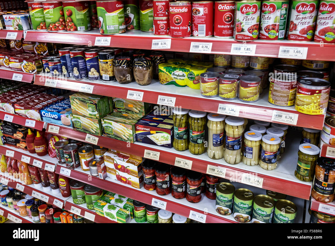 Toledo Spain,Europe,Spanish,Hispanic canned food,vegetables,tomato sauce,can,jar,grocery store,supermarket,display case sale,shelf shelves,interior in Stock Photo