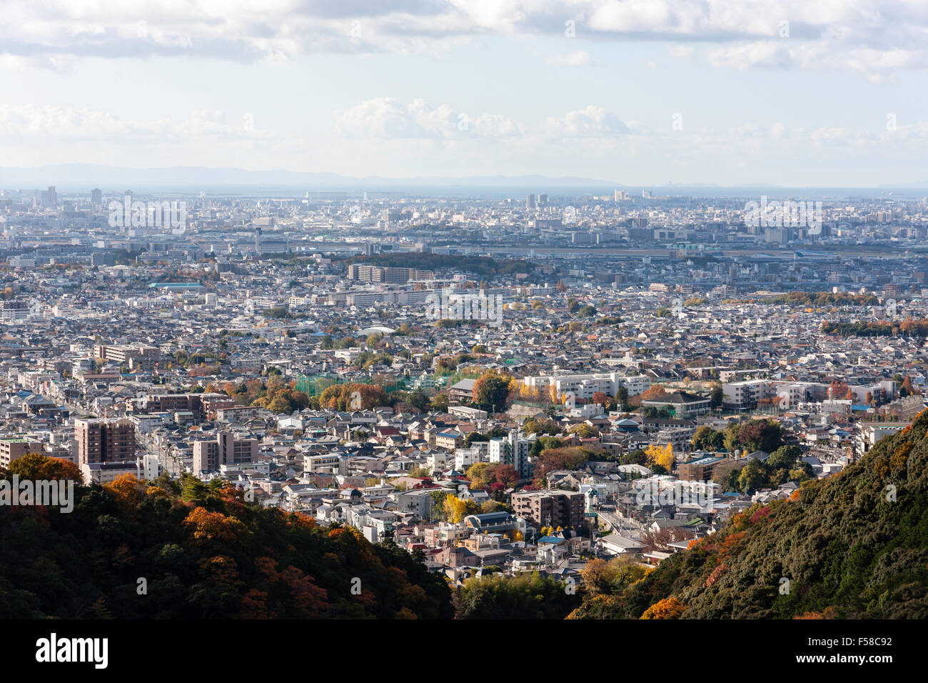 Japan Famous scenic view from mountains at Mino of Osaka city sprawling to the coast with the Yodo river flowing through. Blue sky with clouds. Stock Photo
