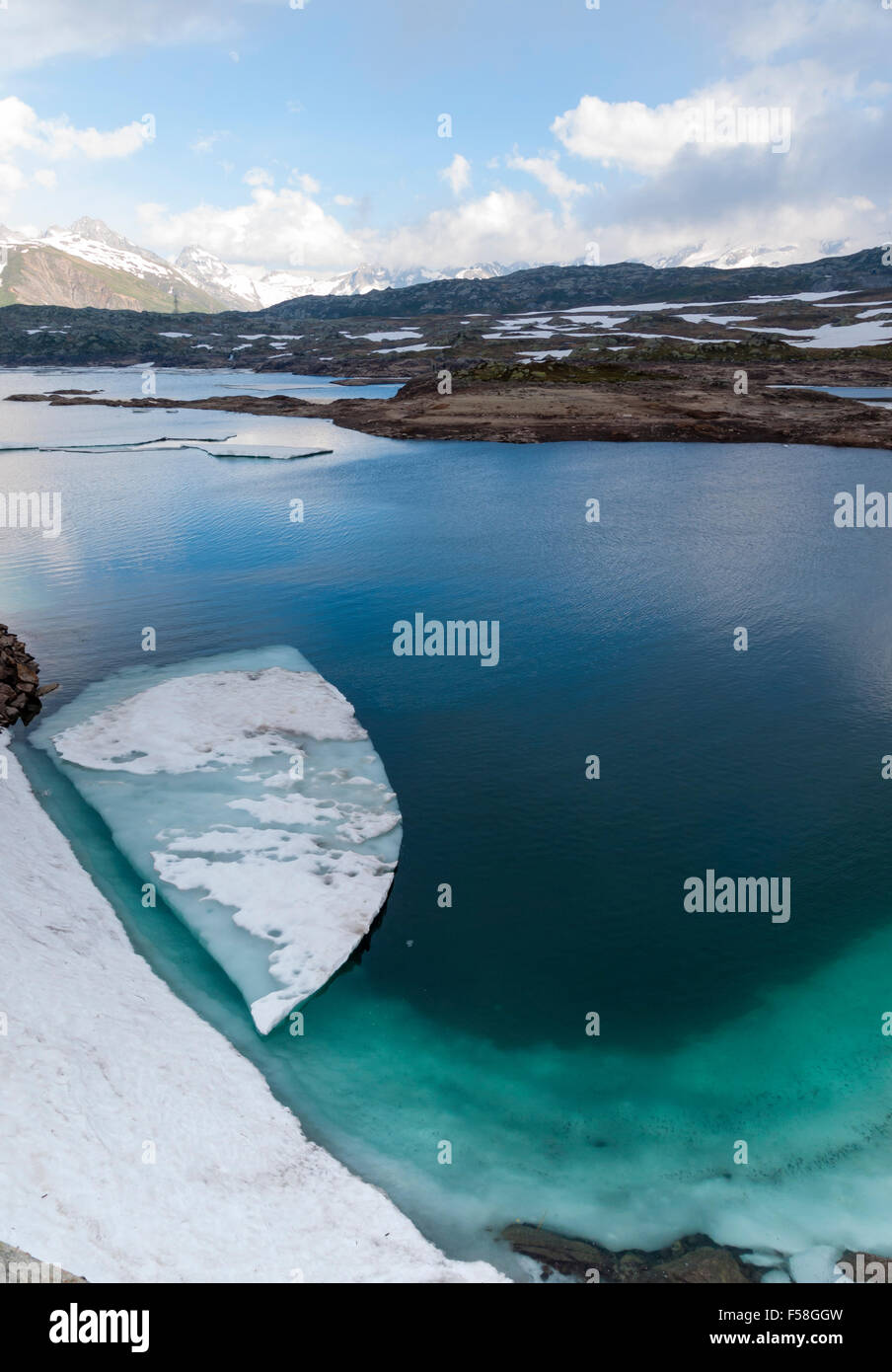 Sheet of ice are floating in the glacial lake 'Totensee' on top of the Grimsel pass, Switzerland (altitude 2165m). Stock Photo