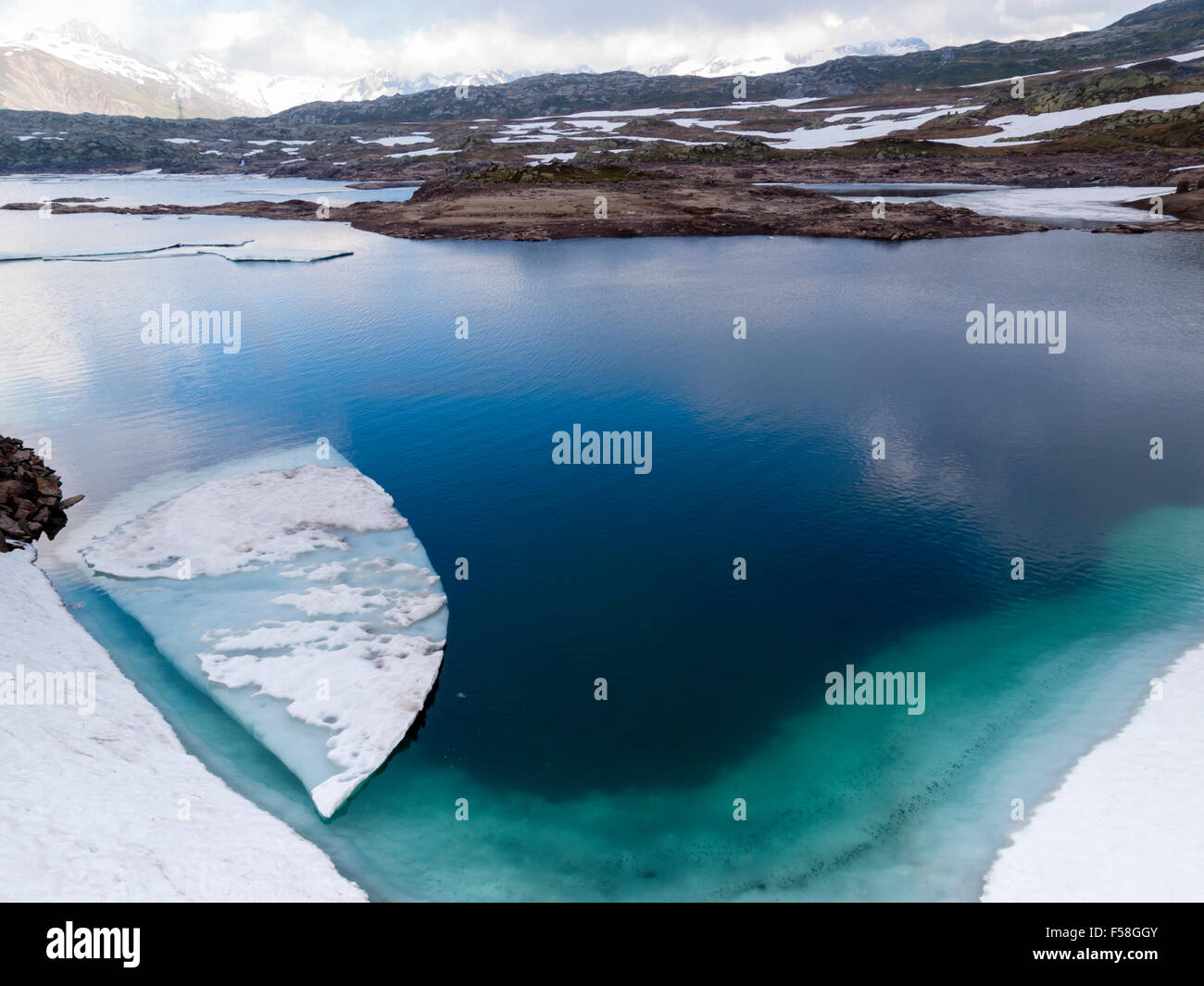 Sheet of ice are floating in the glacial lake 'Totensee' on top of the Grimsel pass, Switzerland (altitude 2165m). Stock Photo