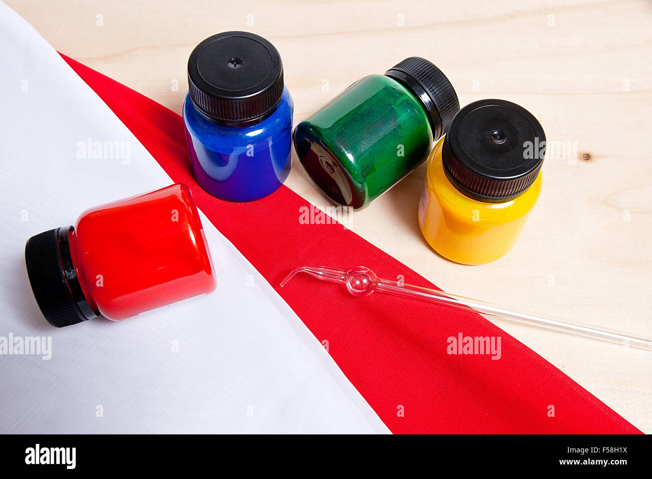 Equipment for cold batik painting isolated on white background. Close up view of different color batik paints and glass tube for Stock Photo