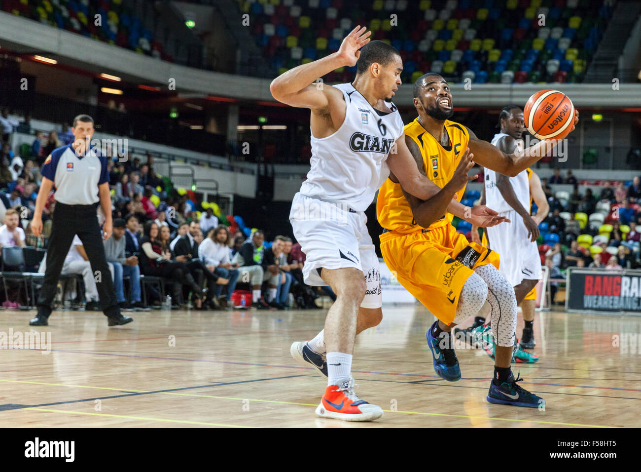 London, UK. 29th Oct, 2015. Lions player Jaron Lane (5) drives the ball forward with Manchester's Sam Attah (6) trying to block during the London Lions vs. Manchester Giants BBL game at the Copper Box Arena in the Olympic Park. Manchester Giants win 90-82. Credit:  Imageplotter/Alamy Live News Stock Photo