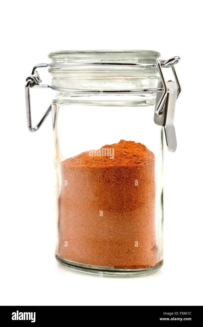 Red pepper powder in jar isolated on white Stock Photo