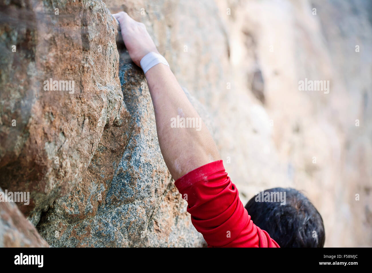 Rock climber's hand on handhold Stock Photo
