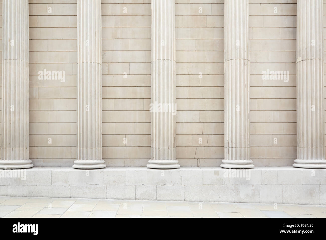 White classical columns and wall background with stone floor Stock Photo