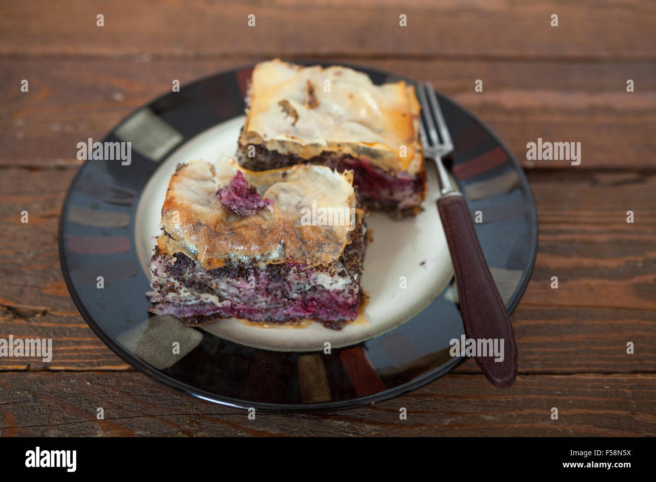 Homemade sweet pastry made of layers of filo filled with chopped nuts, poppy seed, cherry and