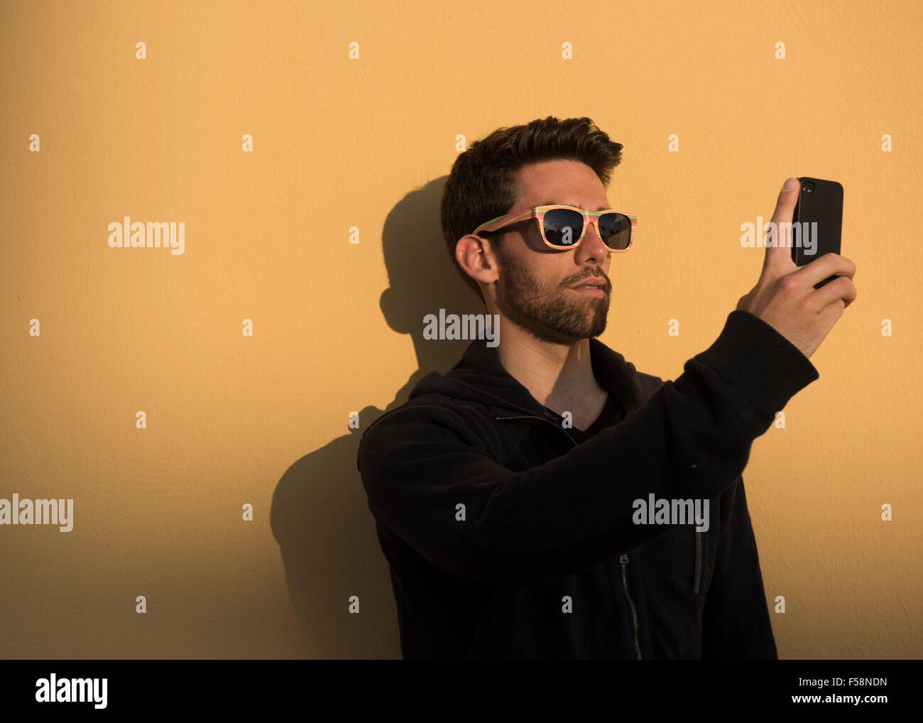 A Man Using Phone Insta Man using his smart phone Stock Photo - Alamy