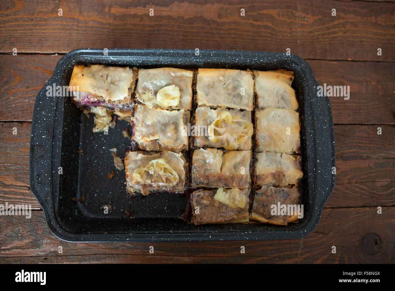 Homemade sweet pastry made of layers of filo filled with chopped nuts, poppy seed, cherry and