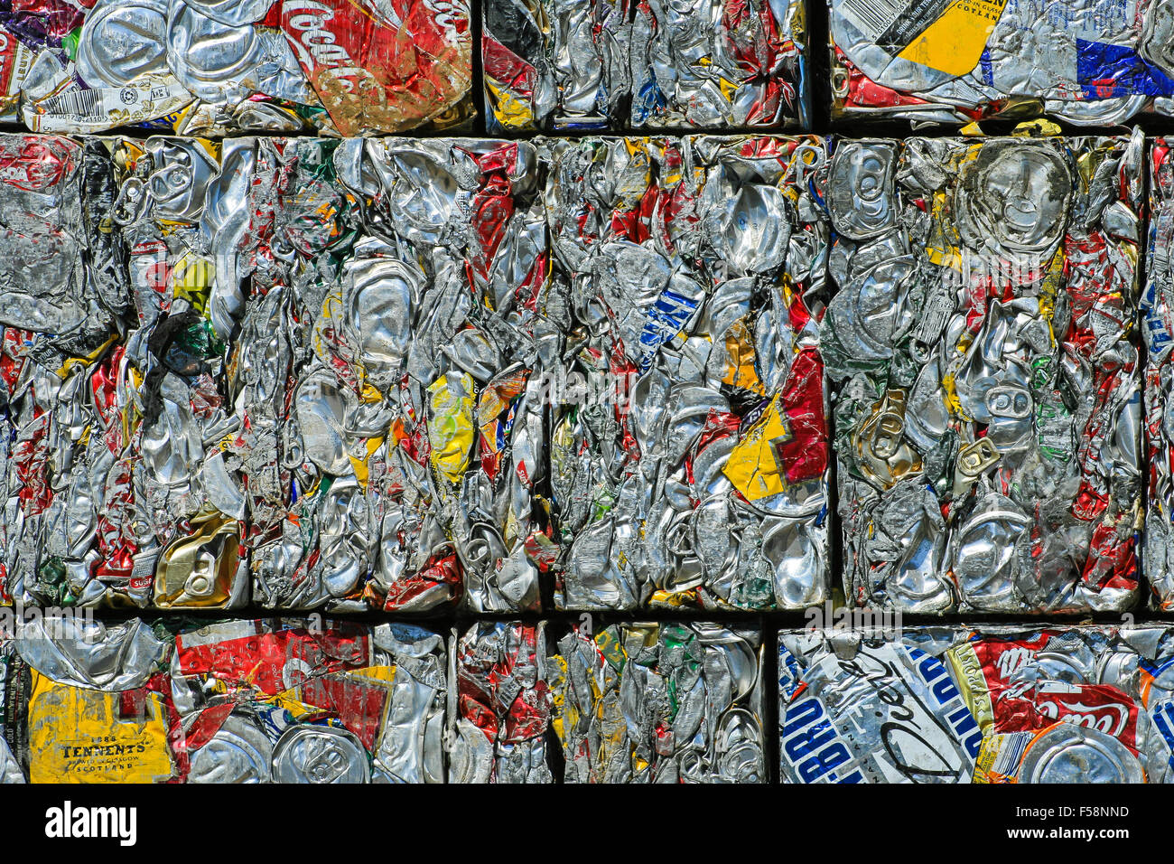 a stack of compressed aluminium cans awaiting recycling in a scrap yard