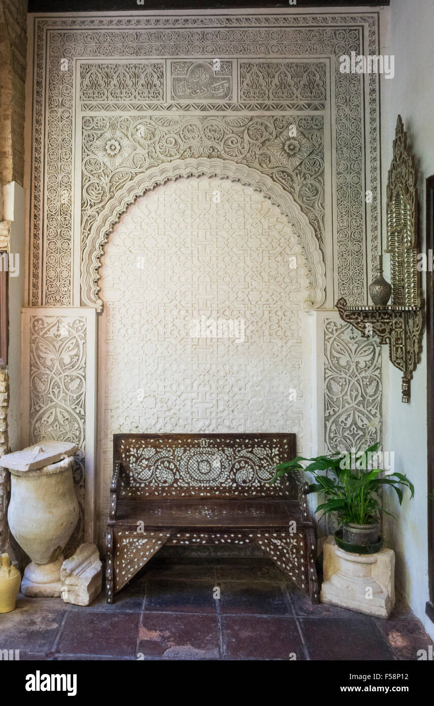 Ornate carved moorish bench and alcove in courtyard in Jewish quarter of Cordoba, Spain, Europe Stock Photo
