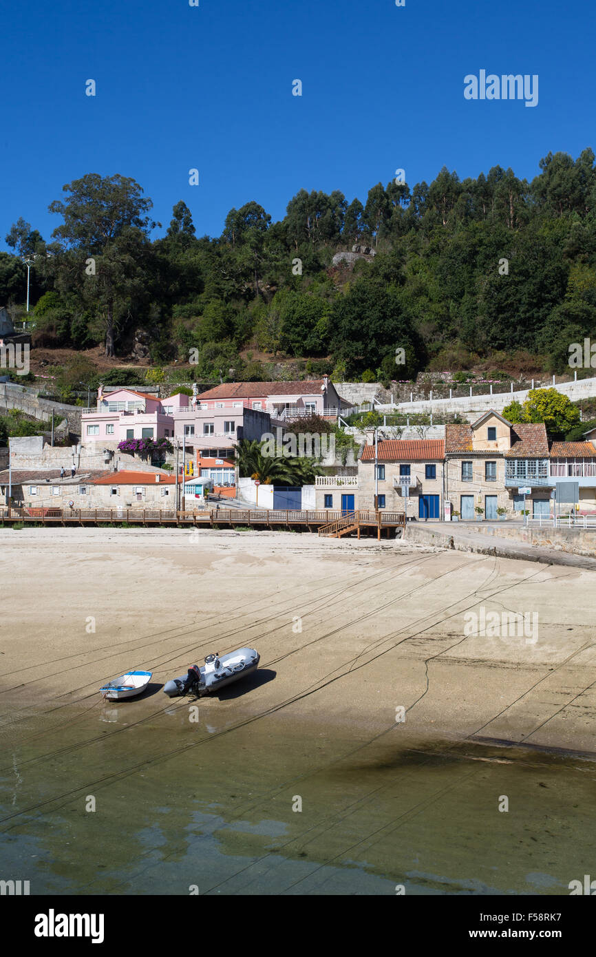 boats on the beach at Bueu, Galicia, Spain with ropes running into the sea Stock Photo