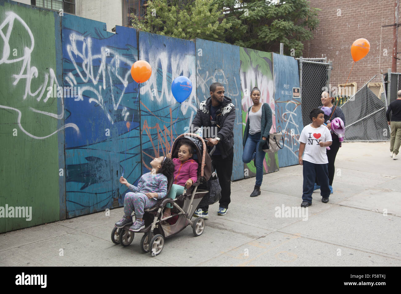 Brooklyn family walks up Atlantic Avenue during a street fair in Brooklyn, NY. Stock Photo