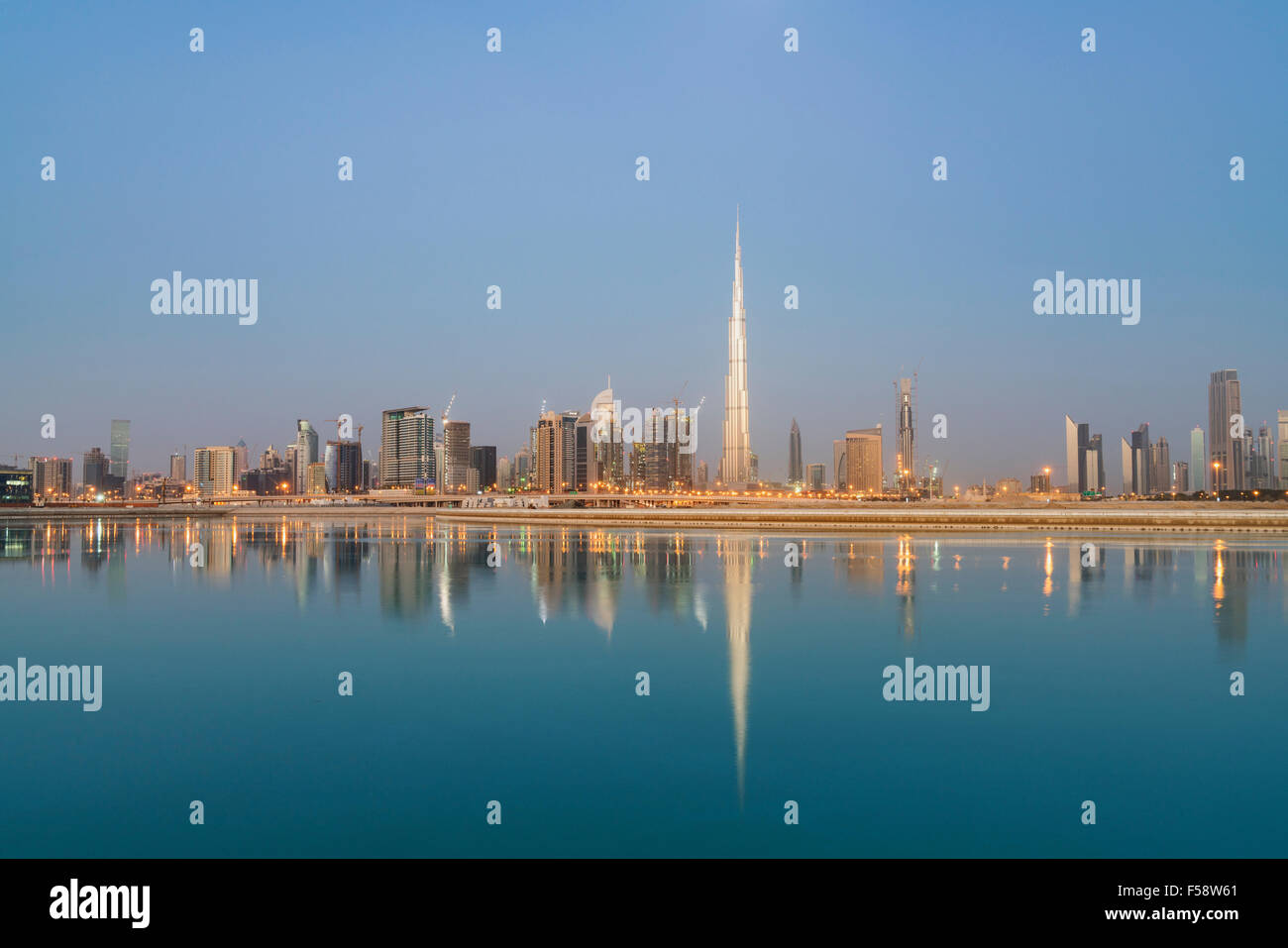 Skyline of skyscrapers and Burj Khalifa tower before sunrise in Dubai United Arab Emirates Stock Photo