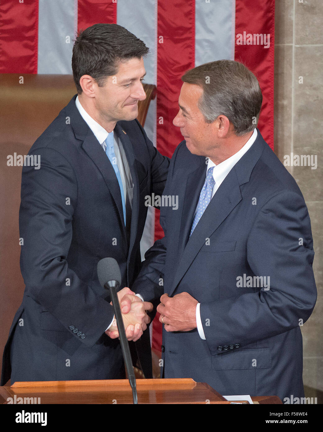 Washington, DC, USA. 29th October, 2015.  Incoming Speaker of the United States House of Representatives Paul Ryan (Republican of Wisconsin), left, is welcomed to the podium by outgoing Speaker John Boehner (Republican of Ohio), right, as Ryan assumes his duties of the office in the US House Chamber in the US Capitol in Washington, DC on Thursday, October 29, 2015. Credit:  dpa picture alliance/Alamy Live News Stock Photo