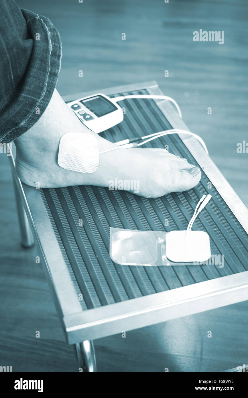 Patient foot, leg and ankle in electro physiotherapy electrical impulse