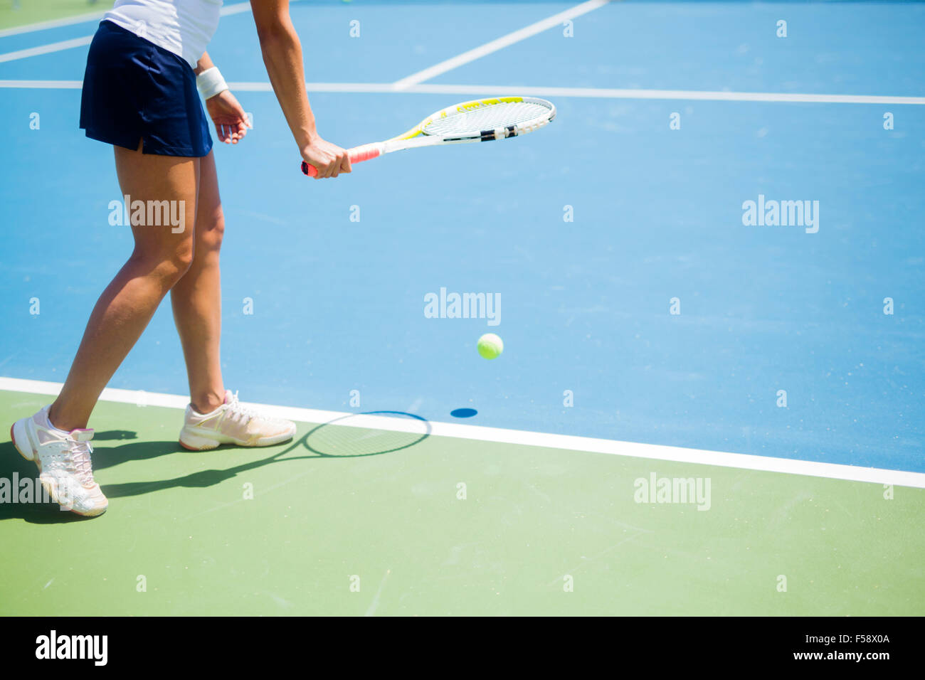 Beautiful female tennis player serving outdoor Stock Photo