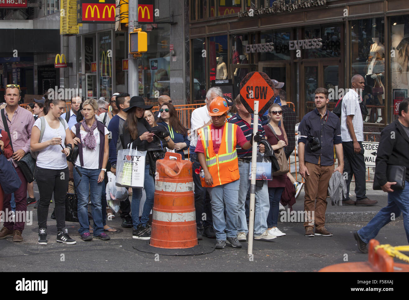 Female construction worker on the job directing people & traffic to