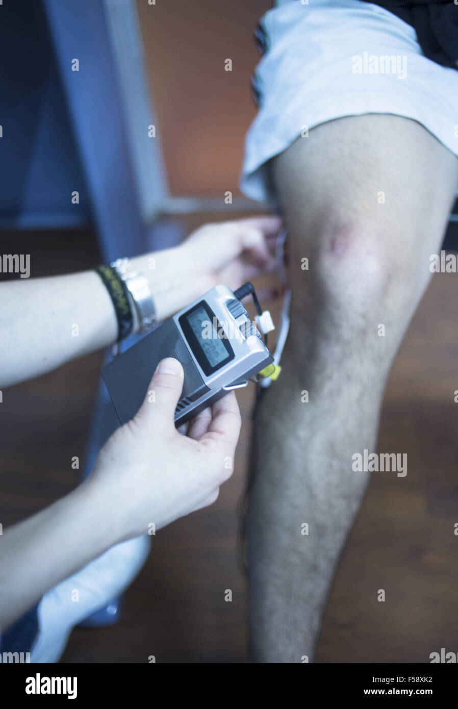 Patient knee, leg, thigh and calf in physiotherapy electrical impulse